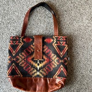 Approx 12 “ high purse with earth tones front pattern and black soft canvas back